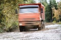 The dump truck moves on a muddy road