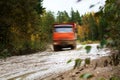 The dump truck moves on a muddy road Royalty Free Stock Photo