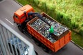 The dump truck takes out glass bottles for recycling. Recycling sorting. Waste recycling. Zero waste. A lot of bottles. Worker top