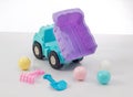 Dump truck toy downloading plastic balls isolated on white Royalty Free Stock Photo