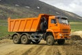 Dump truck is turns on a mountain road Royalty Free Stock Photo