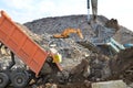 Dump truck unloading of broken concrete slabs demolition waste on landfill. Reuse concrete. Salvaging and recycling building and