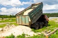 The dump truck unloads sand. The truck dumped the cargo. Sand and gravel. Construction site, materials warehouse Royalty Free Stock Photo