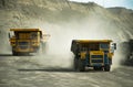 Dump trucks on a coal mine on a Sunny day Royalty Free Stock Photo