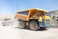 Dump trucks moving in a mine Royalty Free Stock Photo