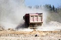 Dump trucks work on a sand pit