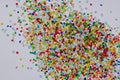 dumped multicolord plastic resin granulate on white background Royalty Free Stock Photo
