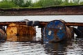 Dumped oil drums cause pollution in the water