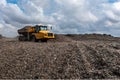 Dumper truck unloading on landfill site Royalty Free Stock Photo