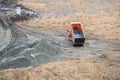 Dumper truck unloading soil or ground at construction site during road works. dumper truck or bulldozer is moving ground Royalty Free Stock Photo