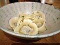 Classic Vareniki dish. Pierogi with Sour Cream in Bowl.