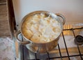 Dumplings in aluminum saucepan on stove Royalty Free Stock Photo