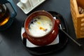 Dumplings baked with cream in clay pot. Russian cuisine