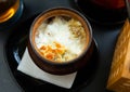 Dumplings baked with cream in clay pot. Russian cuisine