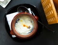 Dumplings baked with cream in clay pot. Russian cuisine