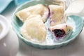 Dumplings with blueberries and cream. Sweet pierogi with berry fruit.