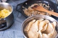 Dumplings are boiled on a stove in a pan with water, tasty lunch