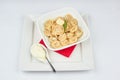 Dumplings with butter and bay leaf on a white background