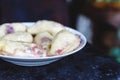 Dumplings with cherries in a plate on a dark retro background Royalty Free Stock Photo