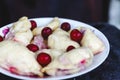 Dumplings with cherries in a plate on a dark retro background Royalty Free Stock Photo