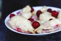 Dumplings with cherries in a plate on a dark retro background Royalty Free Stock Photo
