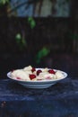 Dumplings with cherries in a plate on a dark retro background Royalty Free Stock Photo