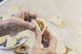 Dumplings. Dough with cabbage filling on the cook`s hands Royalty Free Stock Photo