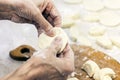 Dumplings. Dough with cabbage filling on the cook`s hands Royalty Free Stock Photo
