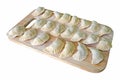 Dumplings in the flour on the cutting board