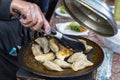 Dumplings frying on grill pan on food stall. Royalty Free Stock Photo