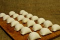 Dumplings at home on wooden cutting Board