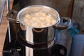 Dumplings in ladle and boiling water in a saucepan