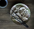 Dumplings in plate on wooden background. Chinese cuisine dish top view photo. Meat dumplings pile in ceramic bowl