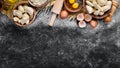 Dumplings with potatoes. Vareniki Homemade. Flour, eggs, dough on a black background.