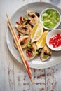 Dumplings styled with lemons green onion and red chili