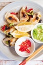 Dumplings styled with lemons green onion and red chili