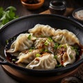 Innovative Asian-inspired Dumplings With Dark Black And Gray Sauce