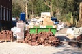 Dumpster and bricks near a construction site Royalty Free Stock Photo