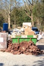 Dumpster and bricks near a construction site Royalty Free Stock Photo
