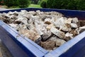 Dumpster filled with sidewalk concrete debris