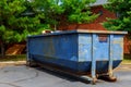 Dumpsters being full with garbage in a city.