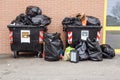 Dumpsters being full with garbage . full waste bin