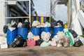 Dumpsters being full with garbage.  Overflowing garbage bins with household waste. overflowing blue garbage bin. Royalty Free Stock Photo