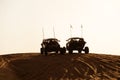 Dune Buggies being driven by tourists at aa Desert Safari park in the red sand dunes near Dubai