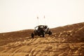 Dune Buggies being driven by tourists at aa Desert Safari park in the red sand dunes near Dubai