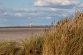 Dune grass with a view of the Westerheversand lighthouse Royalty Free Stock Photo