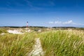 Dune landscape with lighthouse at North Sea Royalty Free Stock Photo