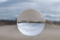 Dunes at the beach seen trough a lensball