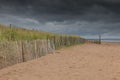 Dunes behind a fence Royalty Free Stock Photo