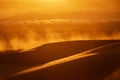 dunes, dust, and backlight at dusk in the desert Royalty Free Stock Photo